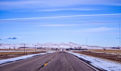 Gray cement road under the blue sky during the day
